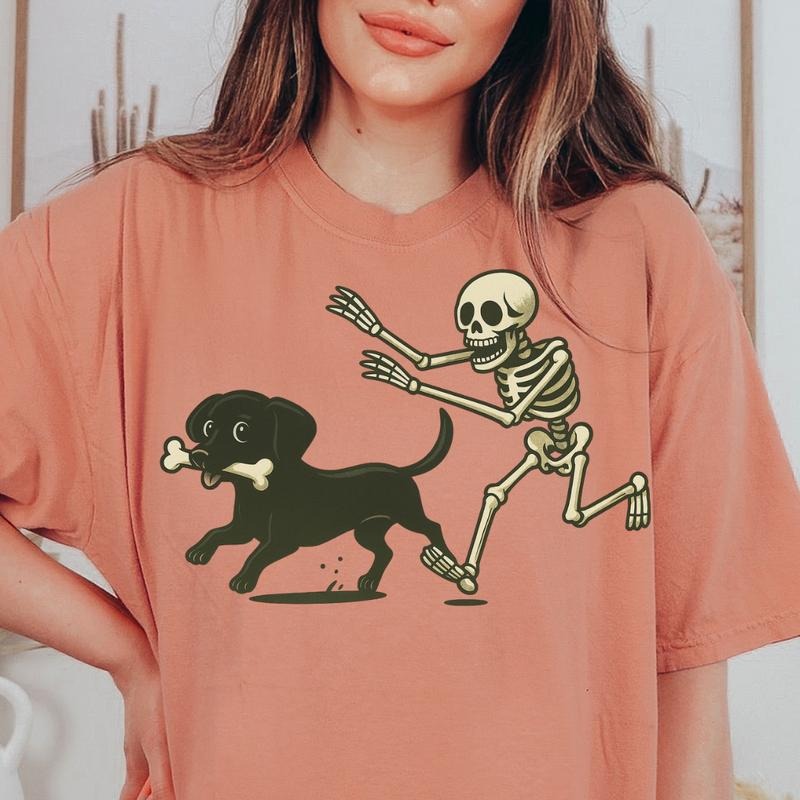 Funny Skeleton Chasing Black Chiweenie Dog Halloween T-Shirt Spooky Graphic Tee Comfort Colors Style Unisex Garment Dyed Heavyweight 100% Ring Spun Cotton Twill Taped Neck & Shoulders
