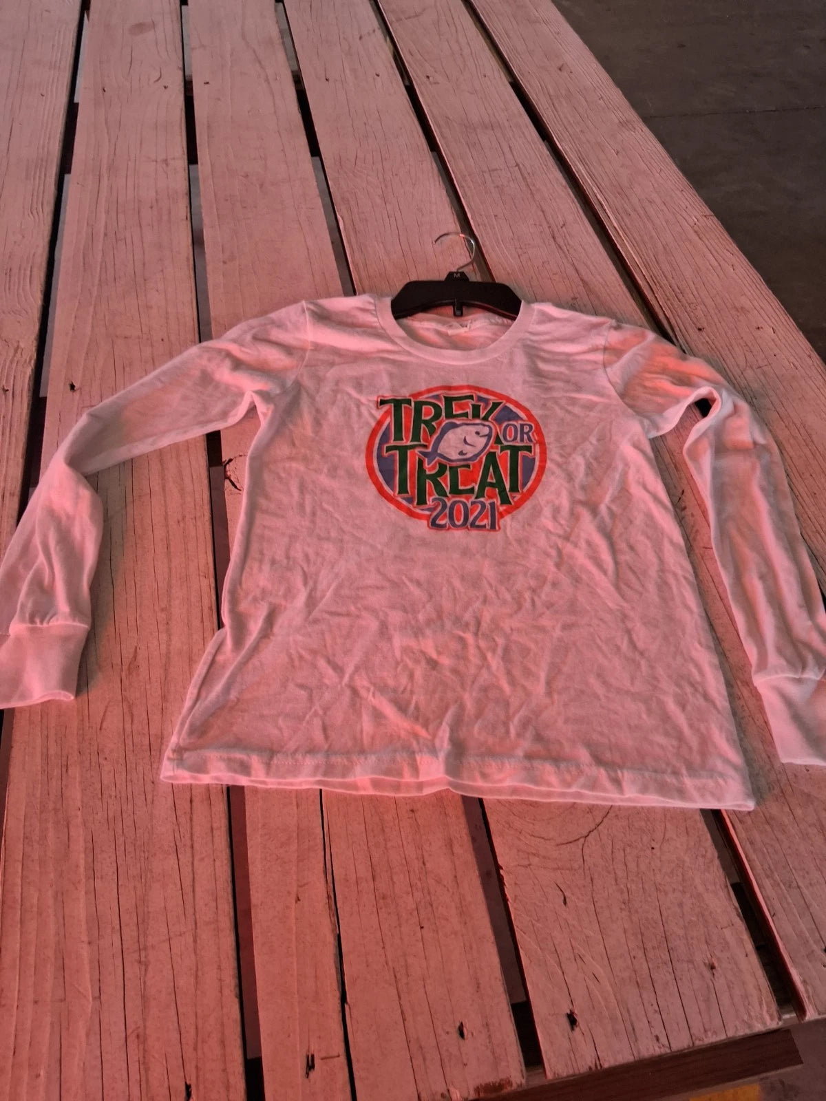 This white long-sleeve t-shirt features a custom graphic for "Trex or Treat...